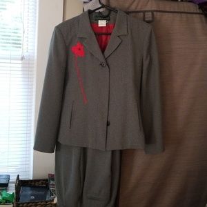 Black pantsuit with red flower on jacket